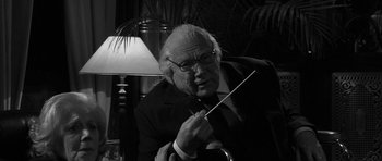 Movie still from “Tetro” (2009), directed by Francis Ford Coppola – An older man holding a conductor's baton in his hand; Close Up shot, Low angle