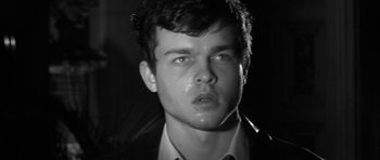 Movie still from “Tetro” (2009), directed by Francis Ford Coppola – Black and white photograph of a young man looking at the camera; Close Up shot, Low angle