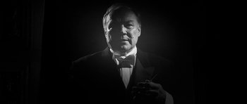 Movie still from “Tetro” (2009), directed by Francis Ford Coppola – A black and white photo of a man in a suit; Close Up shot, Low angle