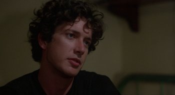 Movie still from “Tex” (1982), directed by Tim Hunter – A person with curly hair; Close Up shot, Over the shoulder angle