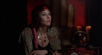 Movie still from “Tex” (1982), directed by Tim Hunter – A woman sitting at a table in front of a clock; Close Up shot, Over the shoulder angle