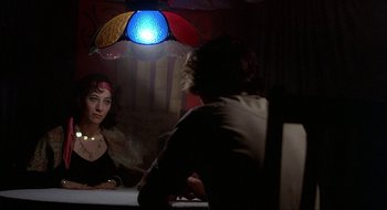 Movie still from “Tex” (1982), directed by Tim Hunter – A woman sitting at a table in front of a man; Close Up shot, Over the shoulder angle