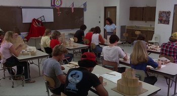 Movie still from “Tex” (1982), directed by Tim Hunter – A group of people sitting in a classroom; Wide shot, Over the shoulder angle