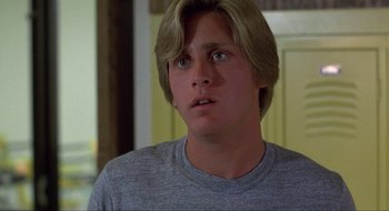 Movie still from “Tex” (1982), directed by Tim Hunter – A man with blonde hair and a gray t - shirt; Close Up shot, Low angle
