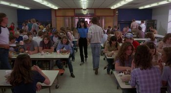 Movie still from “Tex” (1982), directed by Tim Hunter – A group of people sitting at tables in a room; Wide shot, High angle