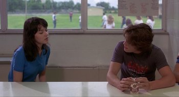 Movie still from “Tex” (1982), directed by Tim Hunter – A man and a woman sitting at a table talking to each other; Medium shot, Over the shoulder angle