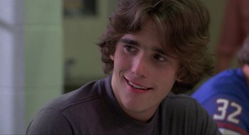 Movie still from “Tex” (1982), directed by Tim Hunter – A young man smiling for the camera; Close Up shot, Over the shoulder angle