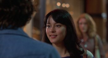 Movie still from “Tex” (1982), directed by Tim Hunter – A young woman is smiling at the camera; Close Up shot, Over the shoulder angle