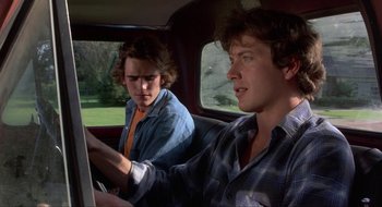 Movie still from “Tex” (1982), directed by Tim Hunter – Two young men in the back seat of a car; Medium shot, Over the shoulder angle