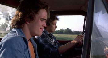 Movie still from “Tex” (1982), directed by Tim Hunter – Two young men are driving in a car; Close Up shot, Over the shoulder angle