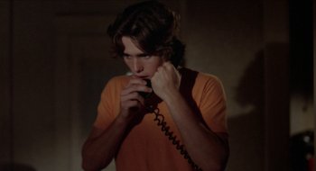 Movie still from “Tex” (1982), directed by Tim Hunter – A young man holding a phone up to his ear; Close Up shot, Low angle