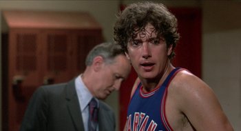 Movie still from “Tex” (1982), directed by Tim Hunter – A man standing next to another man in a room; Close Up shot, Over the shoulder angle