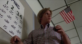 Movie still from “Tex” (1982), directed by Tim Hunter – A man holding a remote control in his hand; Close Up shot, Low angle