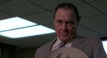 Movie still from “Tex” (1982), directed by Tim Hunter – An older man wearing a suit and tie; Close Up shot, Low angle