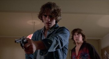 Movie still from “Tex” (1982), directed by Tim Hunter – Two young men playing a video game in a living room; Close Up shot, Low angle