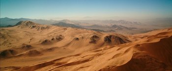 Movie still from “The 33” (2015), directed by Patricia Riggen – A view of a desert with mountains in the background; Extreme Wide shot, High angle