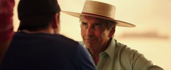 Movie still from “The 33” (2015), directed by Patricia Riggen – An older man wearing a straw hat talking to a younger man; Close Up shot, Over the shoulder angle