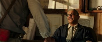 Movie still from “The 33” (2015), directed by Patricia Riggen – An older man shaking hands with a younger man; Medium shot, Over the shoulder angle