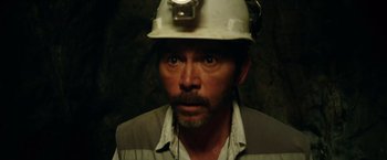 Movie still from “The 33” (2015), directed by Patricia Riggen – A person wearing a hard hat; Close Up shot, High angle