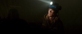Movie still from “The 33” (2015), directed by Patricia Riggen – A man wearing a hard hat with a light on his head; Close Up shot, Low angle