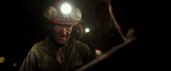 Movie still from “The 33” (2015), directed by Patricia Riggen – A man wearing a hard hat with a light on his head; Close Up shot, Low angle