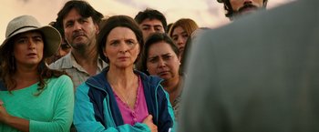 Movie still from “The 33” (2015), directed by Patricia Riggen – A group of people standing next to each other; Medium shot, Over the shoulder angle