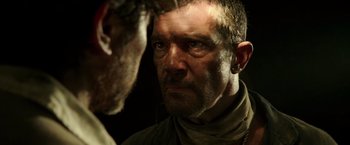 Movie still from “The 33” (2015), directed by Patricia Riggen – A person with a beard; Close Up shot, Over the shoulder angle