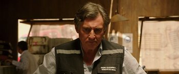 Movie still from “The 33” (2015), directed by Patricia Riggen – A person wearing a vest; Close Up shot, Over the shoulder angle