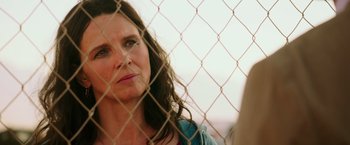 Movie still from “The 33” (2015), directed by Patricia Riggen – A person behind a chain link fence; Close Up shot, Over the shoulder angle