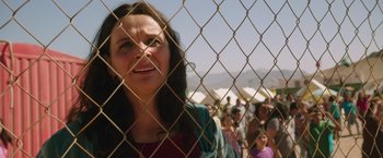 Movie still from “The 33” (2015), directed by Patricia Riggen – A group of people behind a chain link fence; Close Up shot, Over the shoulder angle