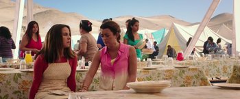 Movie still from “The 33” (2015), directed by Patricia Riggen – A group of women sitting at a table in front of plates; Medium shot, Over the shoulder angle
