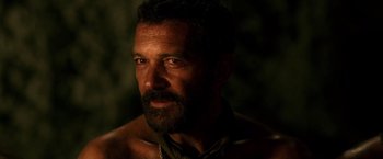 Movie still from “The 33” (2015), directed by Patricia Riggen – A person with a beard looking at the camera; Close Up shot, Over the shoulder angle