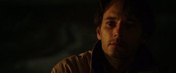 Movie still from “The 33” (2015), directed by Patricia Riggen – A person wearing a brown jacket; Close Up shot, Over the shoulder angle