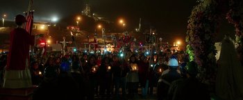 Movie still from “The 33” (2015), directed by Patricia Riggen – A group of people holding lit up candles in the dark; Extreme Wide shot, High angle