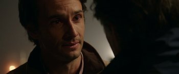 Movie still from “The 33” (2015), directed by Patricia Riggen – A man's face as he stares at something; Close Up shot, Over the shoulder angle