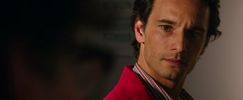 Movie still from “The 33” (2015), directed by Patricia Riggen – A person wearing a red jacket; Close Up shot, Over the shoulder angle