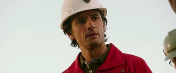 Movie still from “The 33” (2015), directed by Patricia Riggen – A person wearing a hard hat; Close Up shot, Low angle