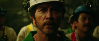 Movie still from “The 33” (2015), directed by Patricia Riggen – A person wearing a hard hat; Close Up shot, Over the shoulder angle