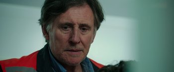 Movie still from “The 33” (2015), directed by Patricia Riggen – An older man is looking into the distance; Close Up shot, Over the shoulder angle