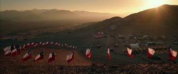 Movie still from “The 33” (2015), directed by Patricia Riggen – A group of kites flying in a field at sunset; Extreme Wide shot, High angle