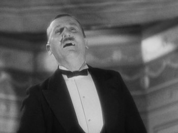 Movie still from “The 39 Steps” (1935), directed by Alfred Hitchcock – A man in a suit and a bow tie; Close Up shot, Low angle