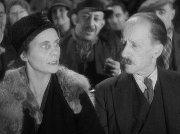 Movie still from “The 39 Steps” (1935), directed by Alfred Hitchcock – An older man and a younger woman are looking at each other; Close Up shot, Over the shoulder angle