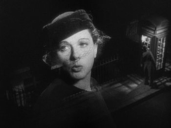 Movie still from “The 39 Steps” (1935), directed by Alfred Hitchcock – An old black and white photo of a woman; Close Up shot, Low angle