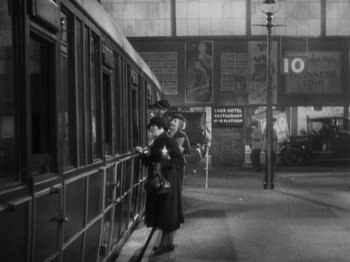 Movie still from “The 39 Steps” (1935), directed by Alfred Hitchcock – A black - and - white photo of people waiting for a train; Extreme Wide shot, Low angle