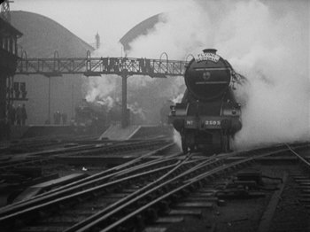 Movie still from “The 39 Steps” (1935), directed by Alfred Hitchcock – A train is coming down the tracks in the fog; Extreme Wide shot, Low angle