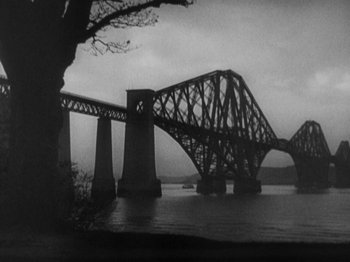Movie still from “The 39 Steps” (1935), directed by Alfred Hitchcock – A black - and - white photo of a bridge over a body of water; Extreme Wide shot, Low angle