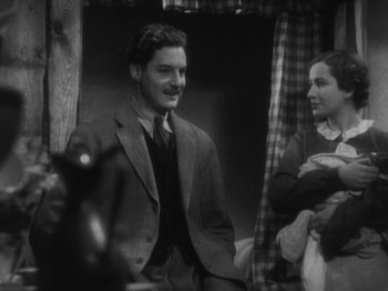 Movie still from “The 39 Steps” (1935), directed by Alfred Hitchcock – A black and white photo of a man and a woman; Medium shot, Over the shoulder angle