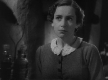 Movie still from “The 39 Steps” (1935), directed by Alfred Hitchcock – An old black and white photo of a young woman; Close Up shot, High angle
