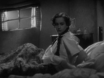 Movie still from “The 39 Steps” (1935), directed by Alfred Hitchcock – A woman sitting on a bed in a room; Close Up shot, High angle