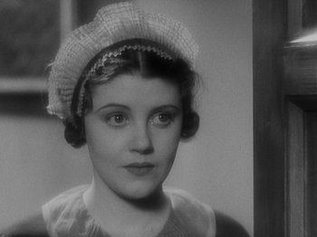 Movie still from “The 39 Steps” (1935), directed by Alfred Hitchcock – A black - and - white photo of a woman wearing a hat; Close Up shot, Over the shoulder angle